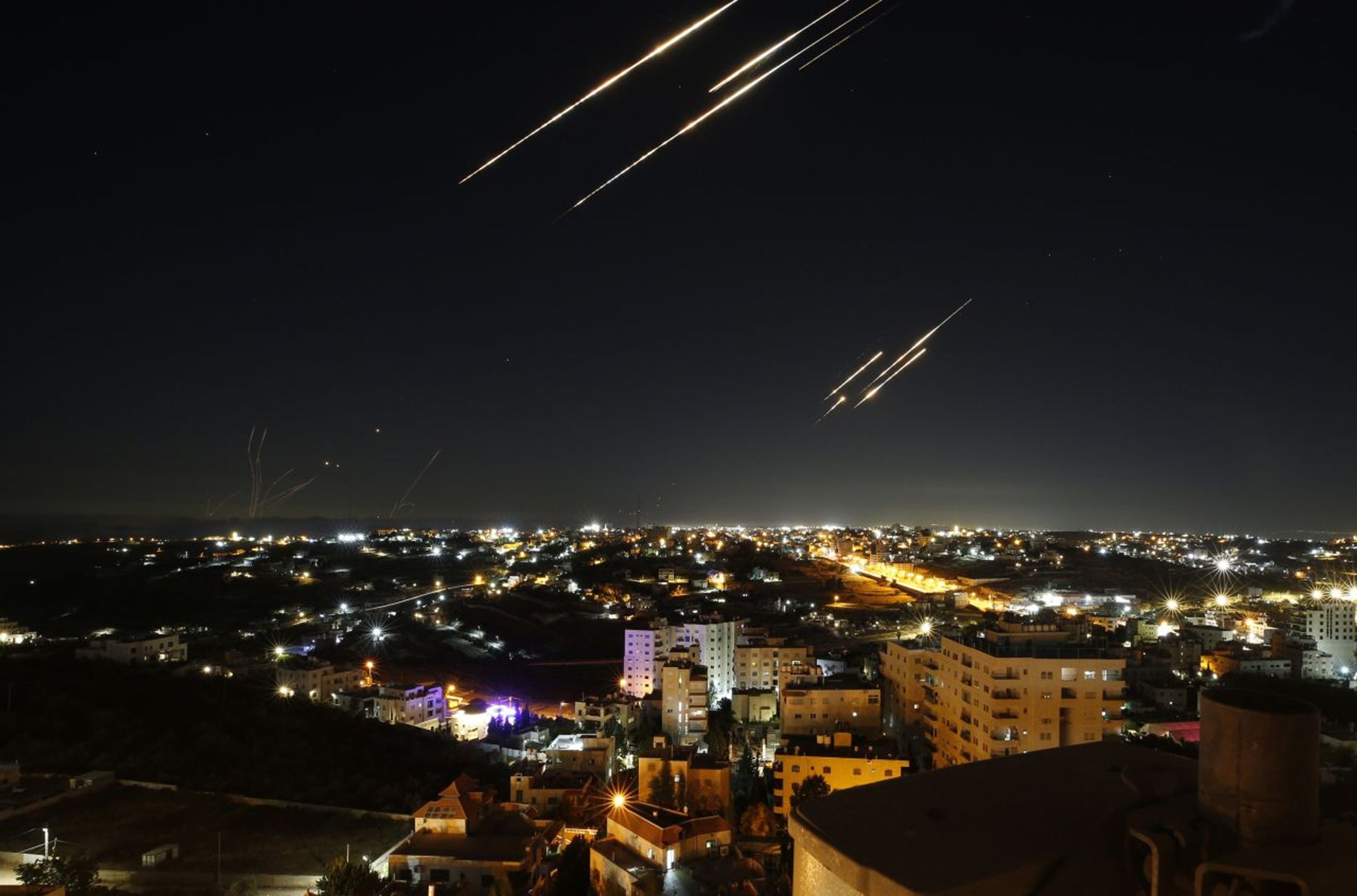 Missiles launched from Iran fly over the sky of Hebron in the West Bank on June 18