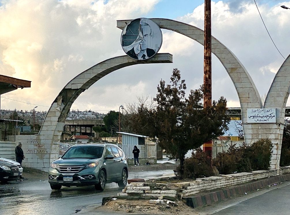A tattered portrait of former Syrian President Hafez al-Assad seen along the road from Damascus to a checkpoint on the Syrian-Lebanese border.