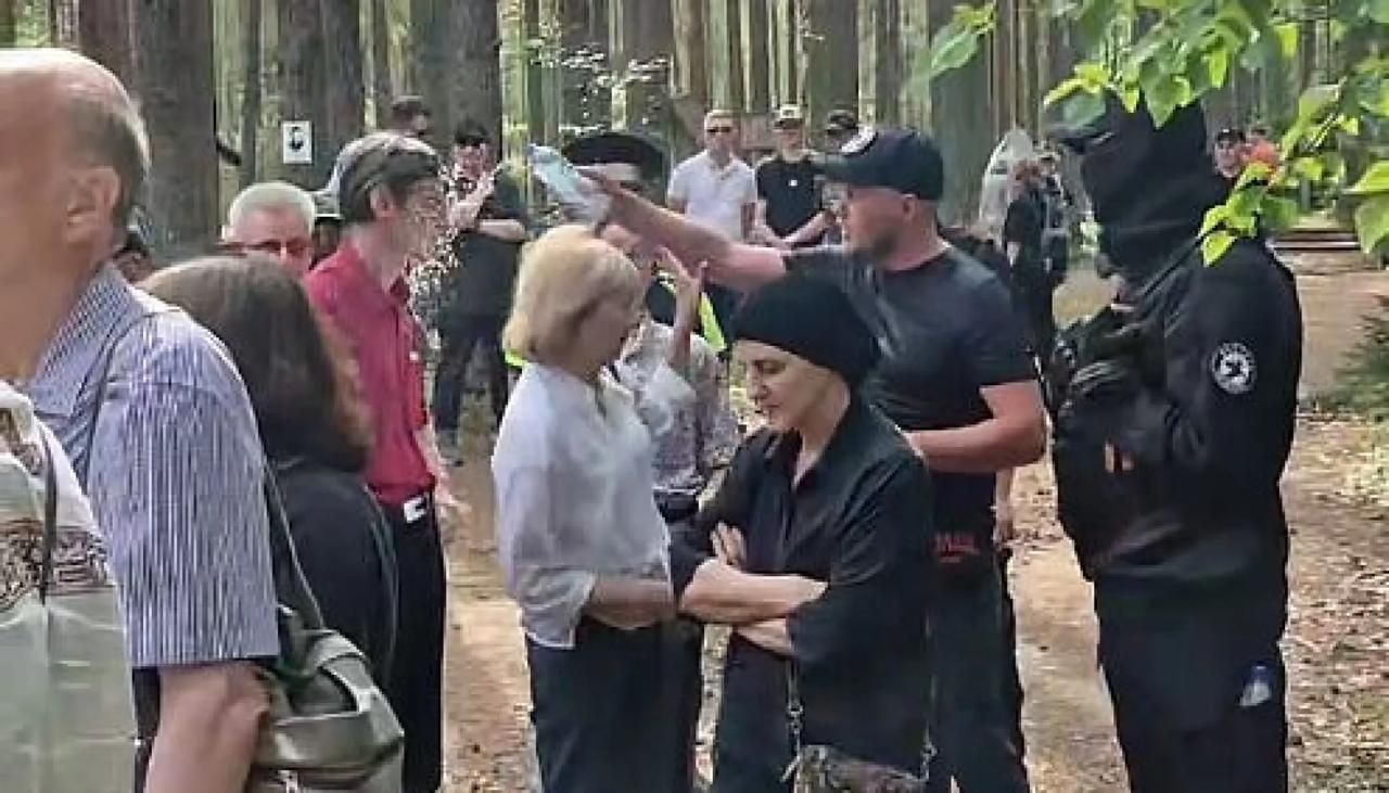 Member of the “Russkaya Obshchina” (lit. “Russian Community”) movement splashes water on a local MP during a memorial event for victims of terror in the Republic of Karelia.