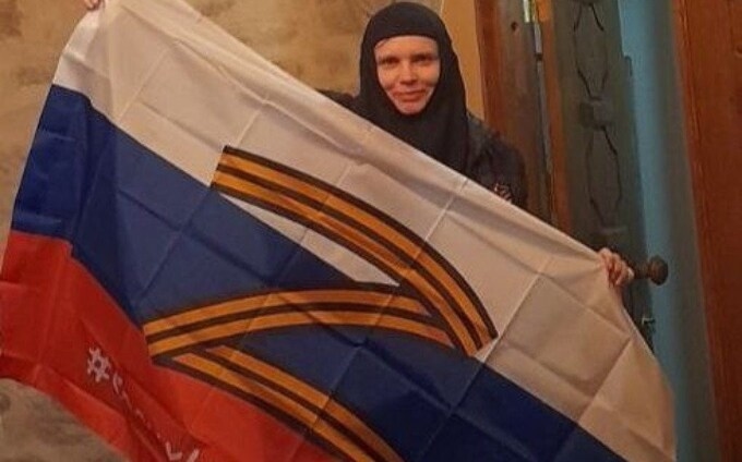 Mother Eugenia, a nun receiving support from the Belarusian St. Elizabeth Monastery, displays a Russian flag with the pro-war symbol “Z.” Photo: St. Elizabeth Monastery.